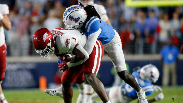 Oct 7, 2023; Oxford, Mississippi, USA; Arkansas Razorbacks tight end Ty Washington (8) catches the ball as Mississippi Rebels defensive back DeShawn Gaddie Jr. (9) make the tackle during the first half at Vaught-Hemingway Stadium. Mandatory Credit: Petre Thomas-USA TODAY Sports